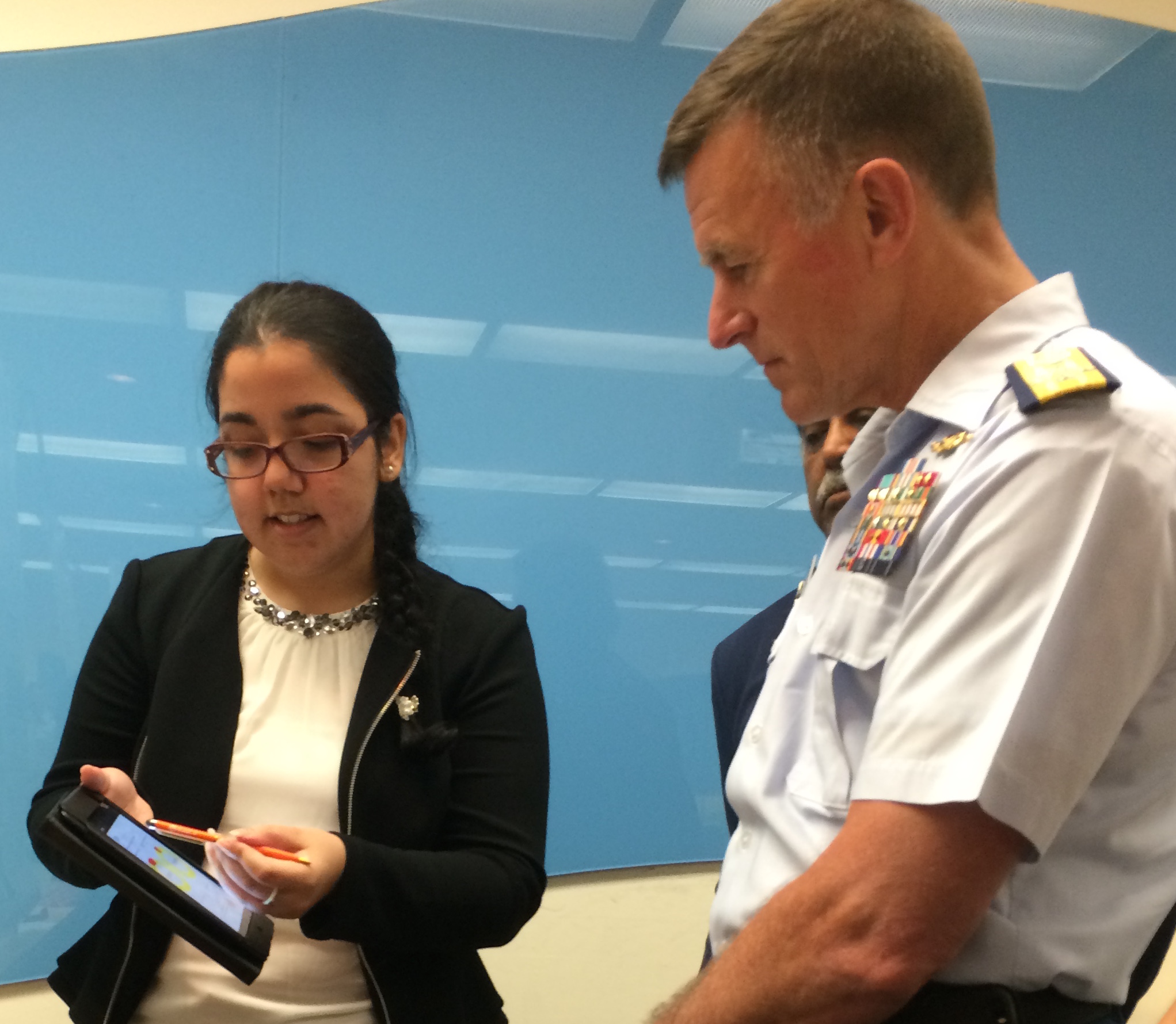 Commandant Paul Zukunft, US Coast Guard, reviews student demo during Computer Science Senior Project Showcase