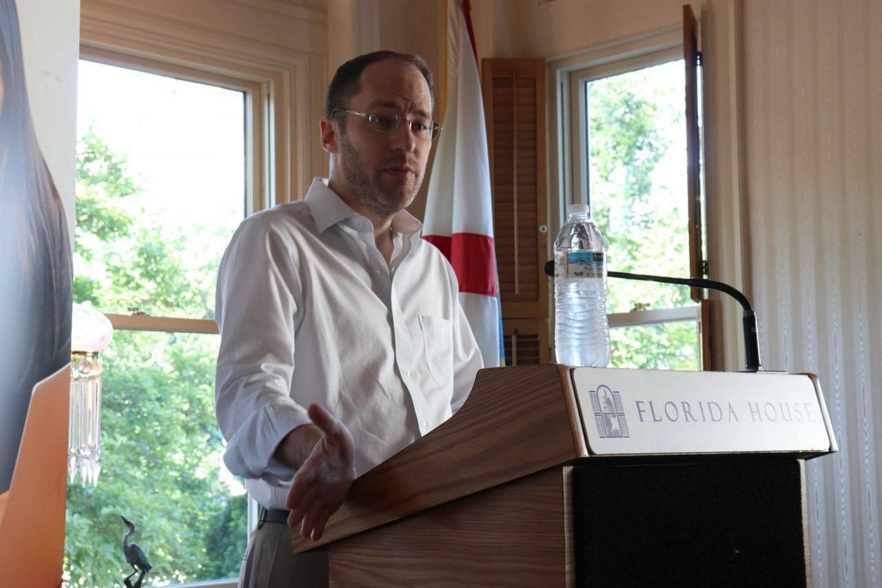 Photo of Dr. Mark Finlayson standing at a podium