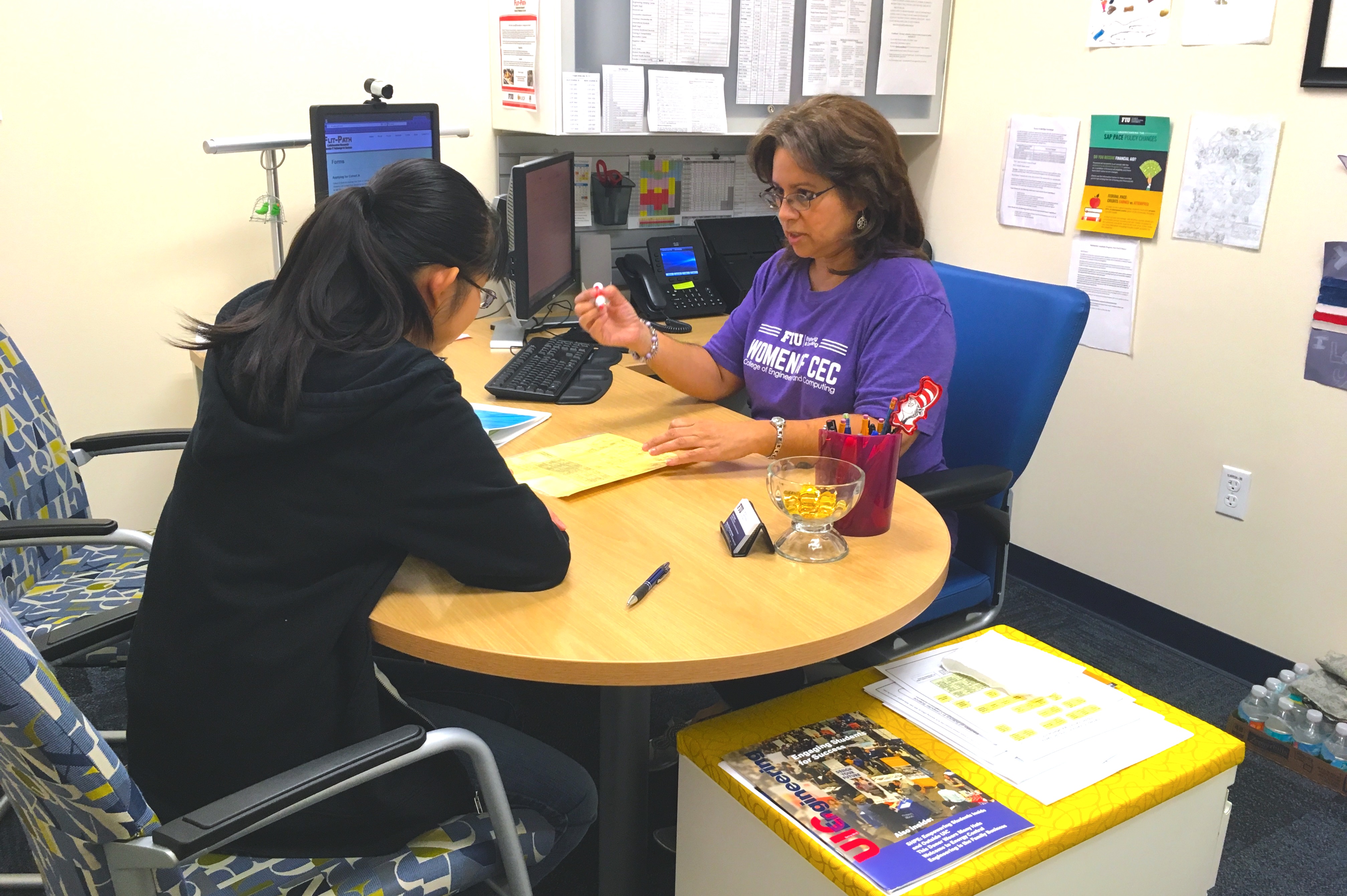 Photo of a #FIUSCIS Advisor with a student